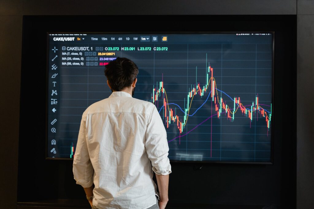 A Man in White Long Sleeves Looking at the Screen, Best Laptop for Trading in 2024: For Day Traders and Investors