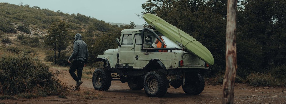 Kayak Strapped to the Back of Car and Man Walking, How to Safely Load Your Kayak onto a Roof Rack in 2024