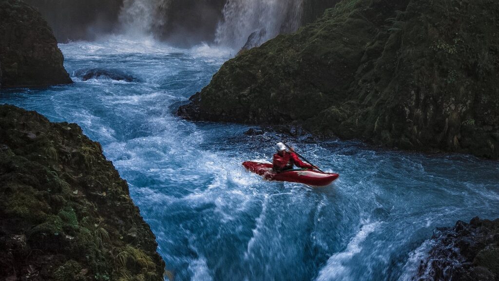Person on Watercraft Near Waterfall, Getting in and out of a kayak